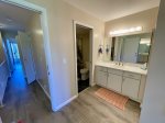 Primary bathroom vanity with separate area for tub/toilet